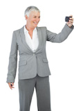 Unsmiling businesswoman calling someone with her mobile phone