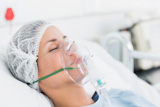 The female patient receives artificial ventilation.