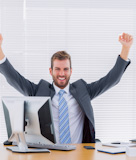 The fist which grasps the cheerful businessman of an office desk tightly