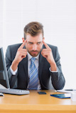 The businessman of a serious headache of an office desk