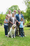 Happy extended family with pet dog at park