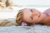 Pretty carefree blonde lying on the beach