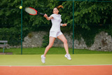 Pretty tennis player about to hit ball