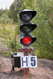 Traffic light shows red signal on railway, Railway station,